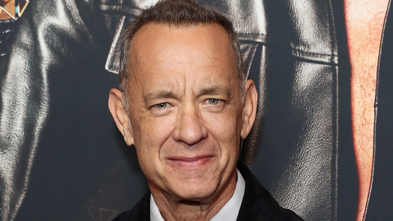 Tom Hanks smiling softly at camera