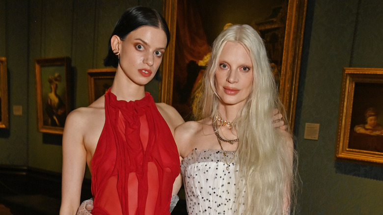 Lily and Kristen McMenamy posing at an event