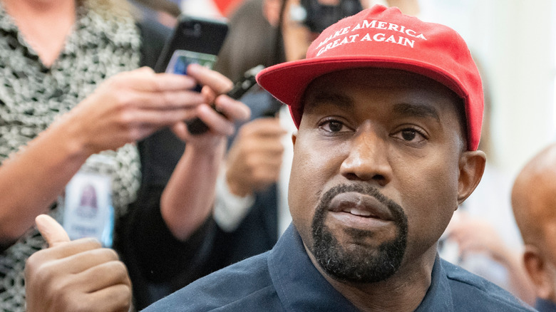 Kanye West wearing a red MAGA hat