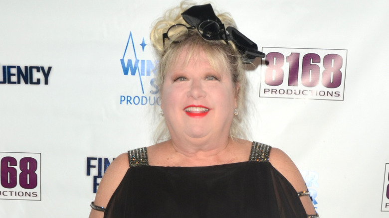 Victoria Jackson in front of a white background with various logos