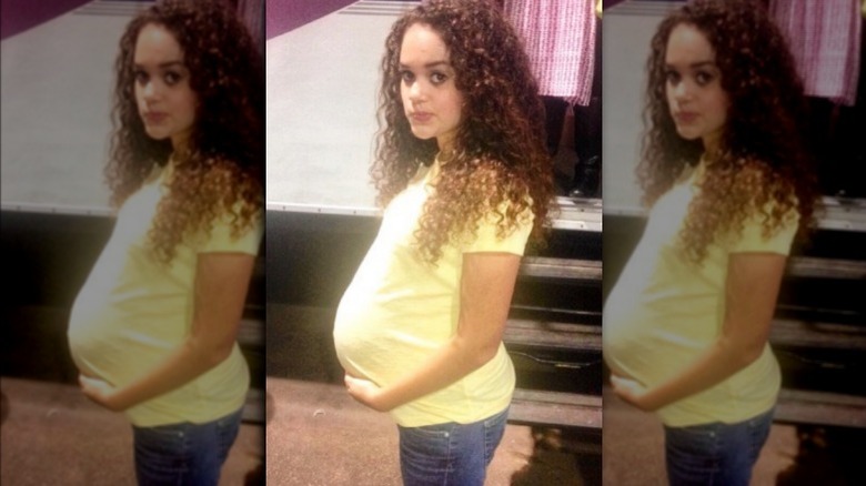 Madison Pettis with prosthetic pregnant belly
