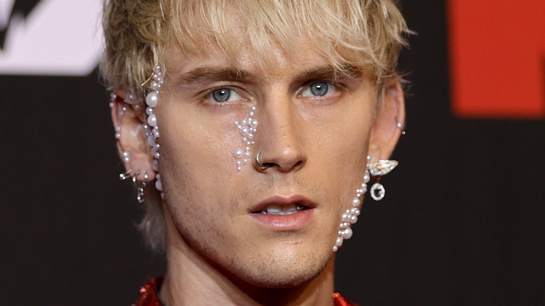 Machine Gun Kelly with bejeweled adornments on his face