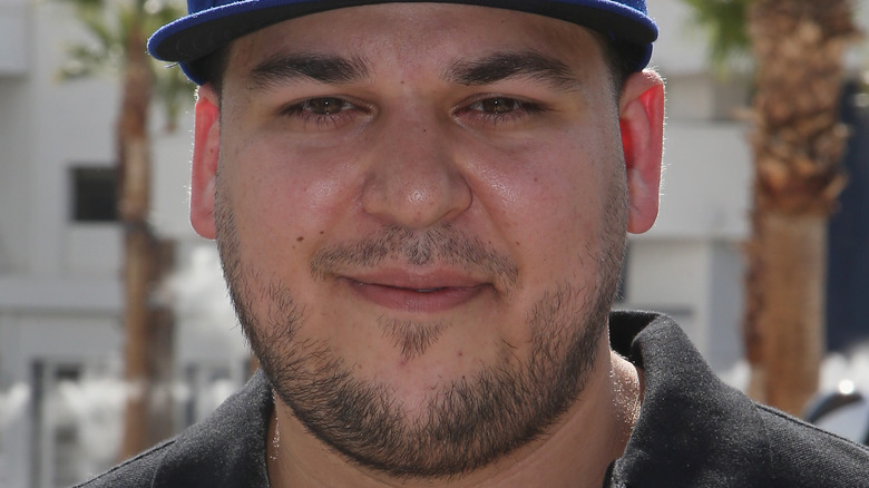 Rob Kardashian smiling beard blue baseball cap