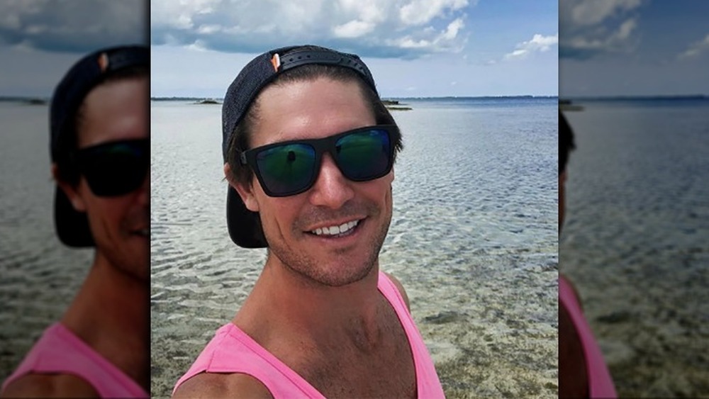 Craig Conover poses in front of water