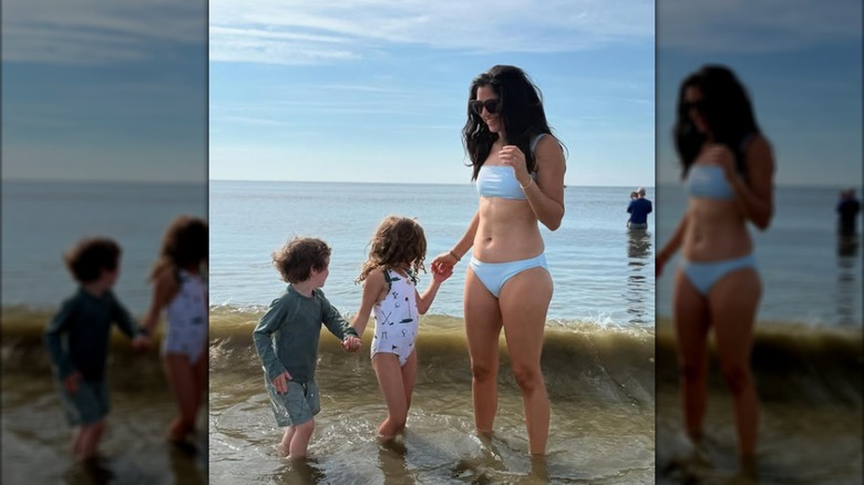 Katie Miller posing with her kids at the beach.