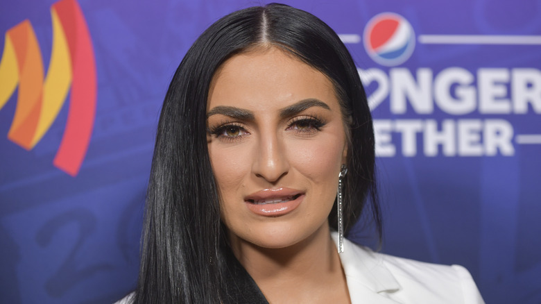 Sonya Deville smiling wearing white