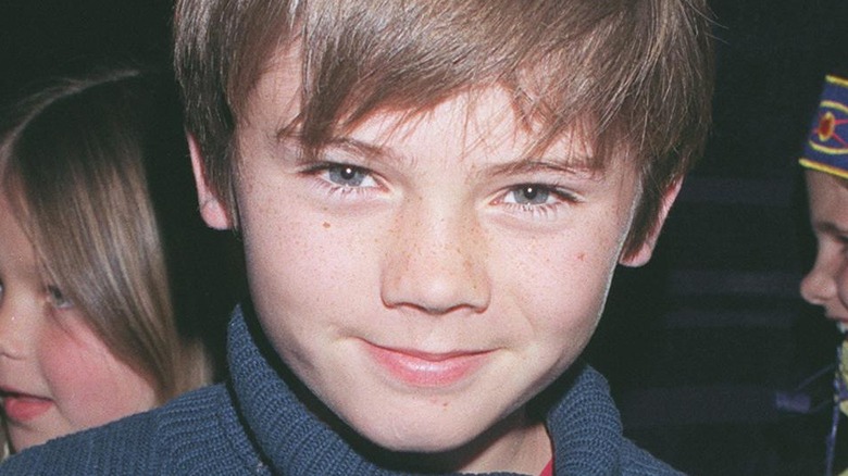 Jake Lloyd smiling at a premiere