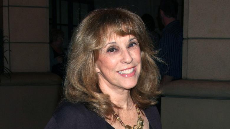 Denise Alexander pictured in front of a dark background