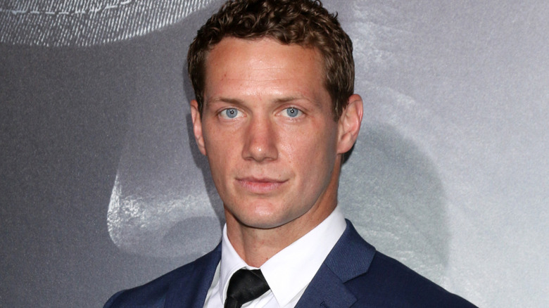 Johnny Wactor posing in front of a grey-blue background