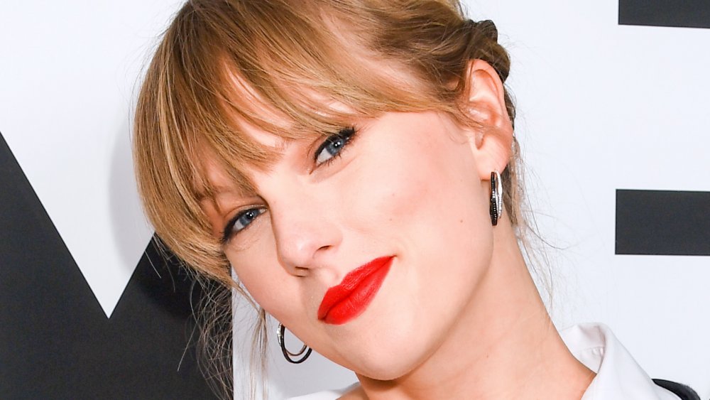 Taylor Swift smirking while tilting her head