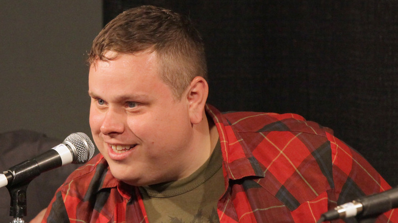 Austin Lucas speaking into a microphone