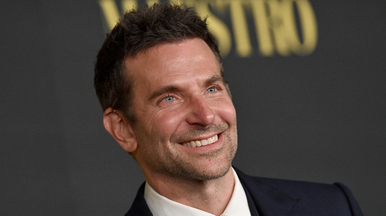 Bradley Cooper smiling with a stubbly beard