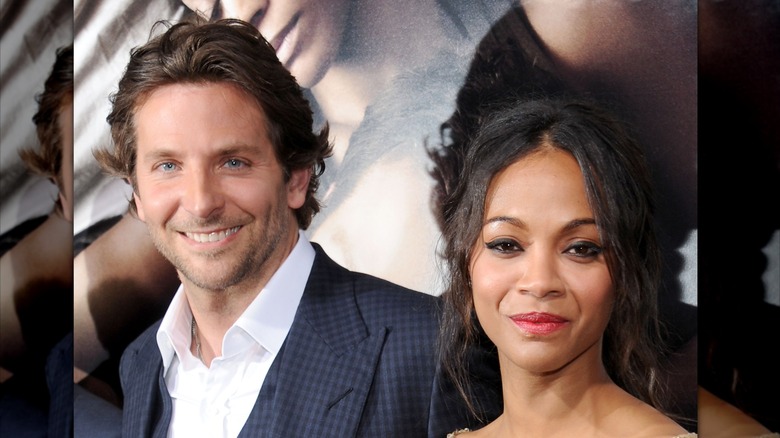 Bradley Cooper and Zoe Saldaña posing on the red carpet