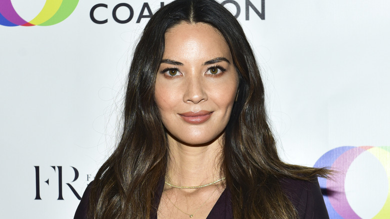 Olivia Munn smiling at promotional event
