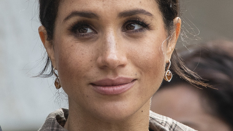 Meghan Markle slightly smiling