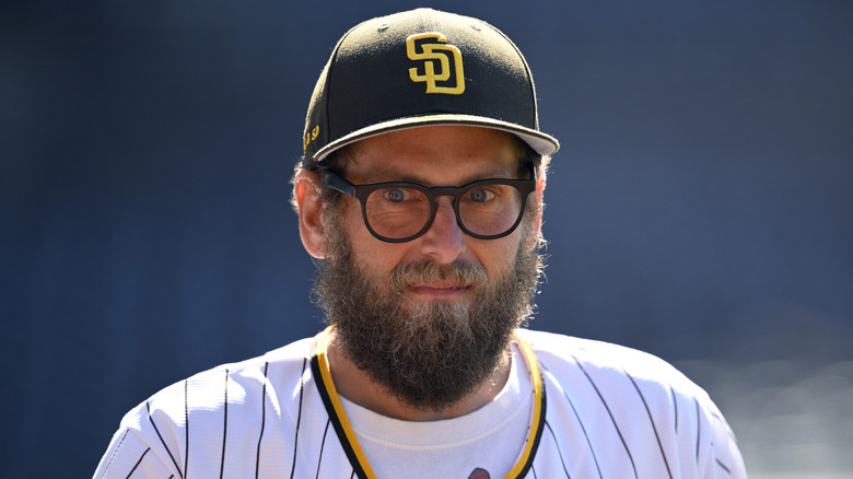 A bearded Jonah Hill in a baseball uniform
