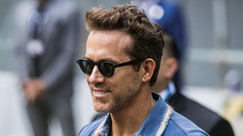 Ryan Reynolds smiles with sunglasses at TIFF in 2025