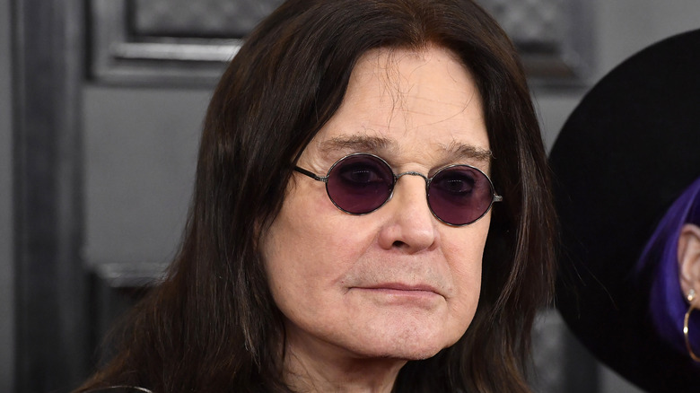 Ozzy Osbourne wearing purple glasses