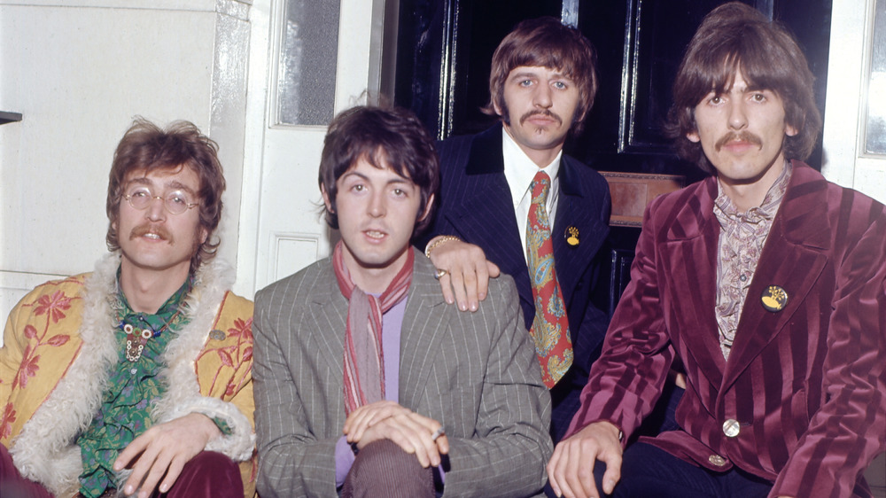 The Beatles posing in jackets