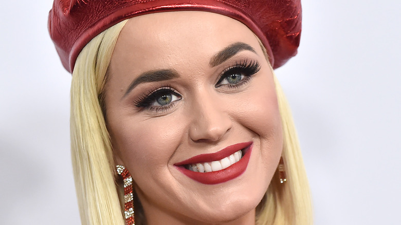 Katy Perry wearing a red hat