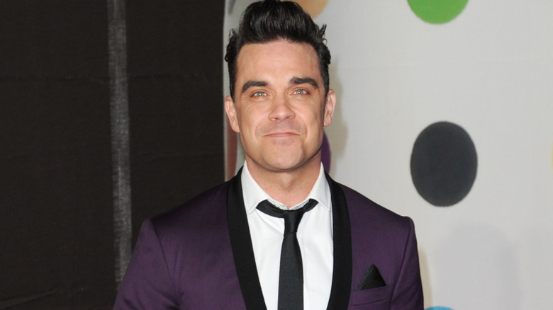 Robbie Williams smirking