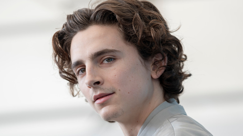 Timothee Chalamet looking over shoulder