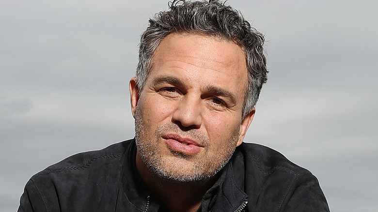 Mark Ruffalo sitting outdoors