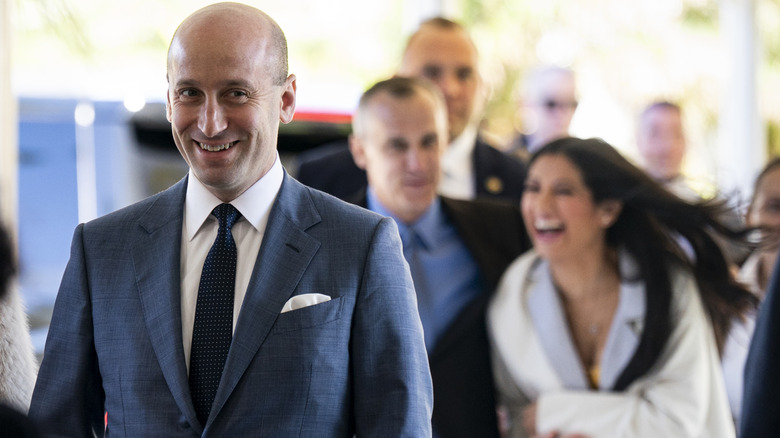 Stephen Miller walking ahead of Katie Miller at Dan Scavino's Mar-a-Lago wedding.