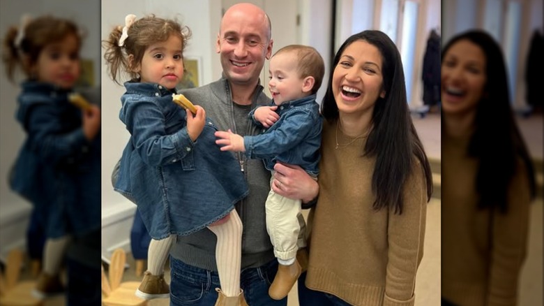 Stephen and Katie Miller posing together with their children.