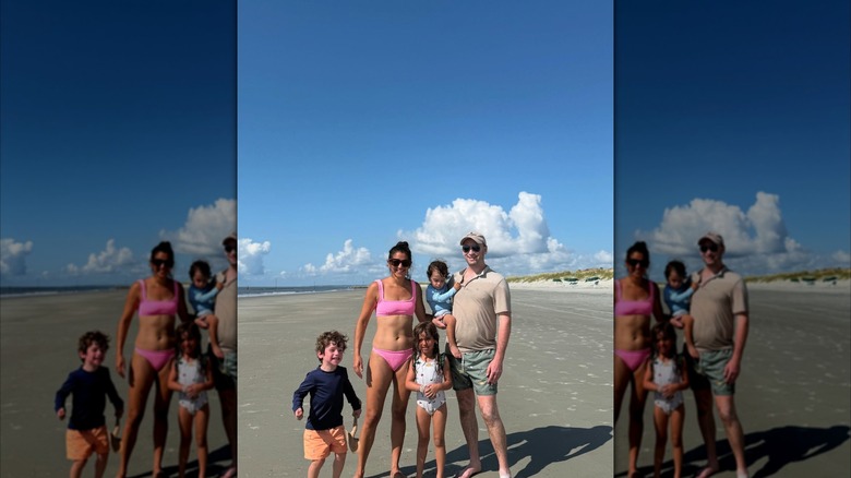Katie Miller and Stephen Miller posing for a family photo on the beach with their children