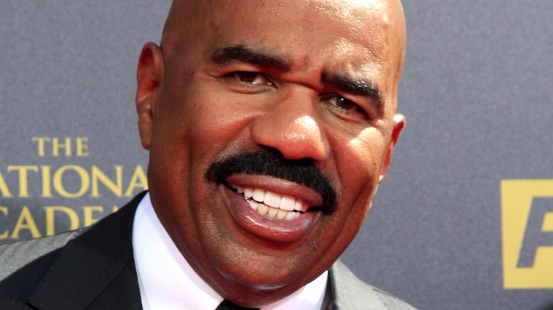 Steve Harvey poses in a suit