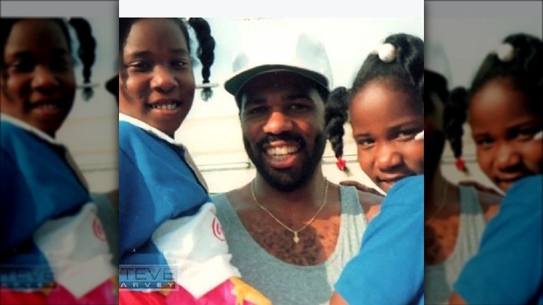 Steve Harvey holding his twin daughters