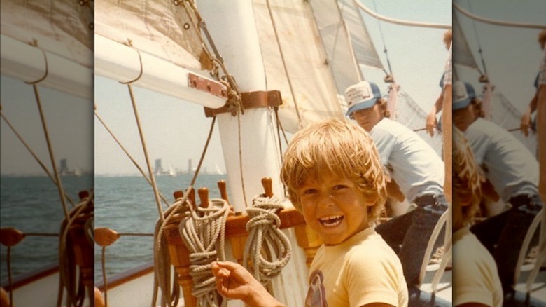 Young Steve Howey on a boat 