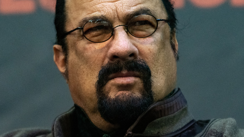 Steven Seagal grimaces in glasses