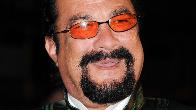 Steven Seagal wearing orange sunglasses