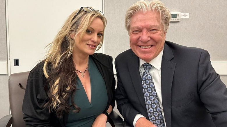 Stormy Daniels lilac suit frowning