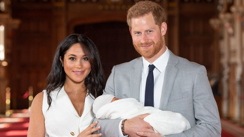 Prince Harry and Meghan Markle, posing with Prince Archie at a photocall