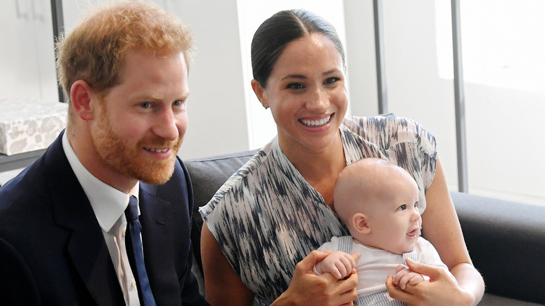 Meghan Markle and Prince Harry, posing with their son Prince Archie