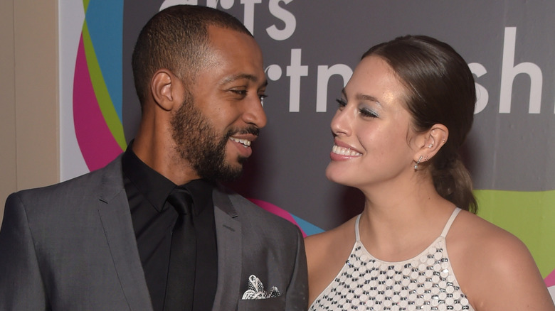 Justin Ervin and Ashley Graham smiling at each other