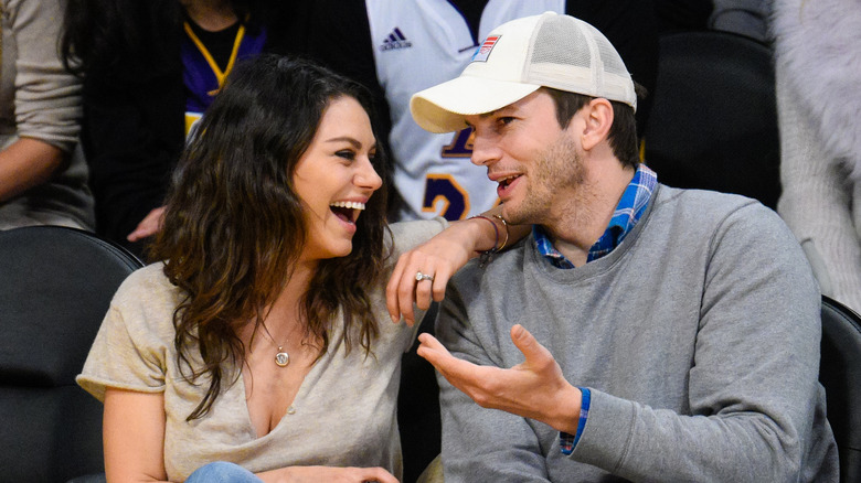Mila Kunis laughing with Ashton Kutcher