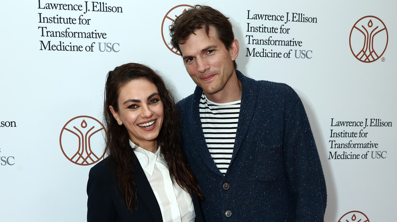 Mila Kunis laughing with Ashton Kutcher