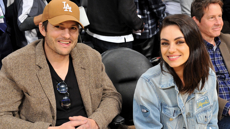 Ashton Kutcher smiling with Mila Kunis