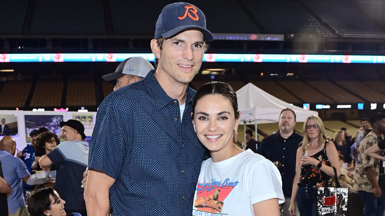 Ashton Kutcher smiling with Mila Kunis