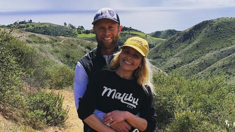 Valeri Bure and Candace Cameron hug outdoors