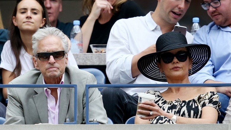 Michael Douglas and Catherine Zeta-Jones at a game