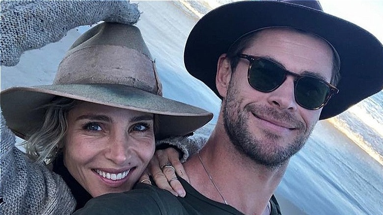 Elsa Pataky and Chris Hemsworth smiling by the sea