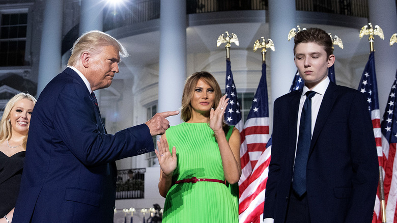 Donald Trump gesturing to Barron Trump