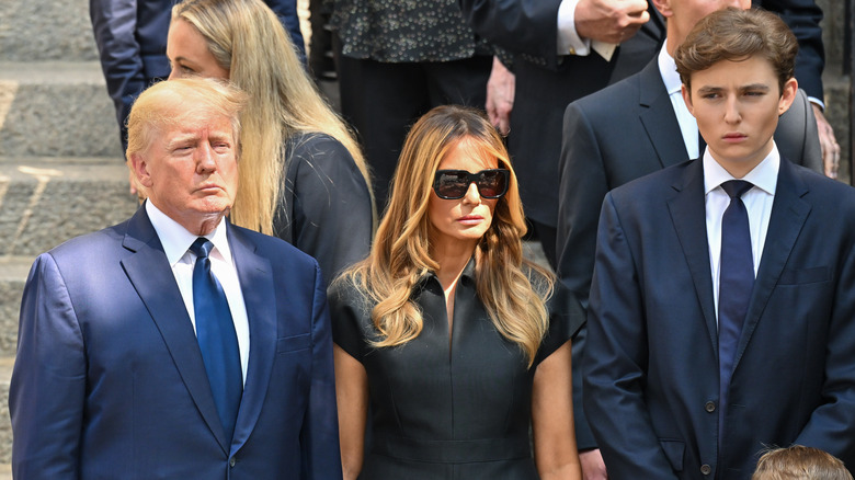 Donald, Melania, and Barron Trump at a funeral