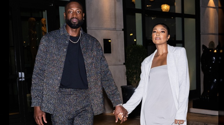 Dwyane Wade and Gabrielle Union hold hands