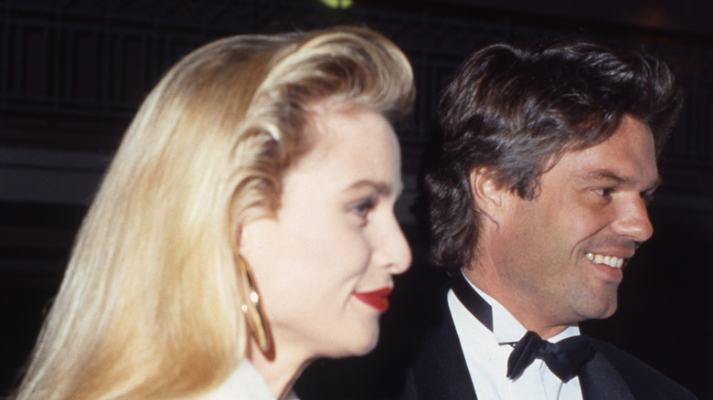 Nicollette Sheridan in white, Harry Hamlin in a black tux, photographed in 1991